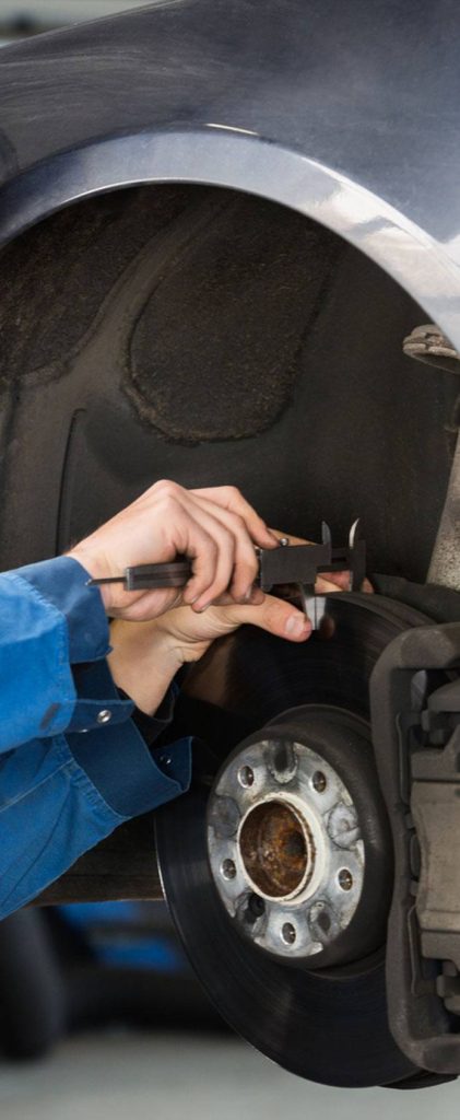 Mechanic Measuring Car Brakes